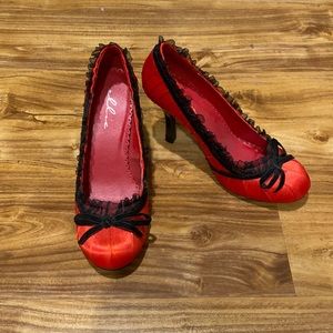 Red and black lace lined high heels